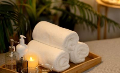 Serviettes de bain, huiles essentielles et bougie pour un moment de détente