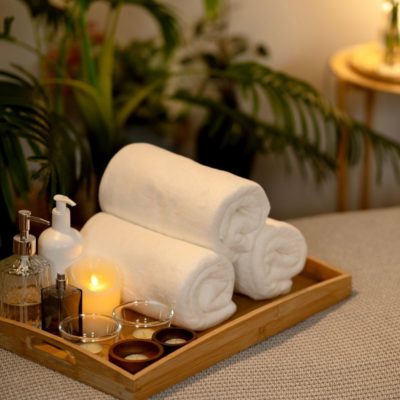 Serviettes de bain, huiles essentielles et bougie pour un moment de détente