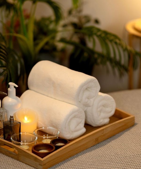 Serviettes de bain, huiles essentielles et bougie pour un moment de détente